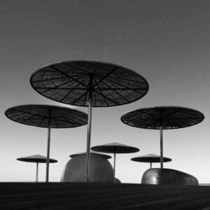 Black and white photo of umbrellas on a pier