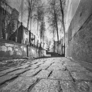 A creatively composed double exposure of a black and white brick walkway