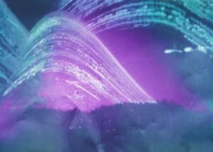 A vibrant purple and green wave against a serene blue background