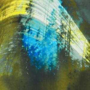 Sun path visible in blurry wood against blue sky