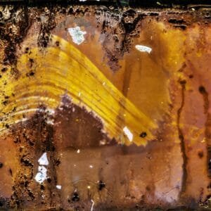 Rusty photopaper with yellow photo, weathered by sun exposure over six months