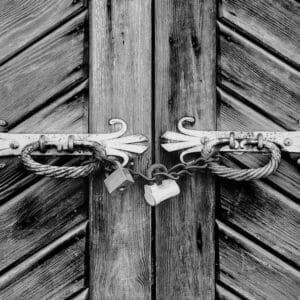 Two padlocks hanging on the door